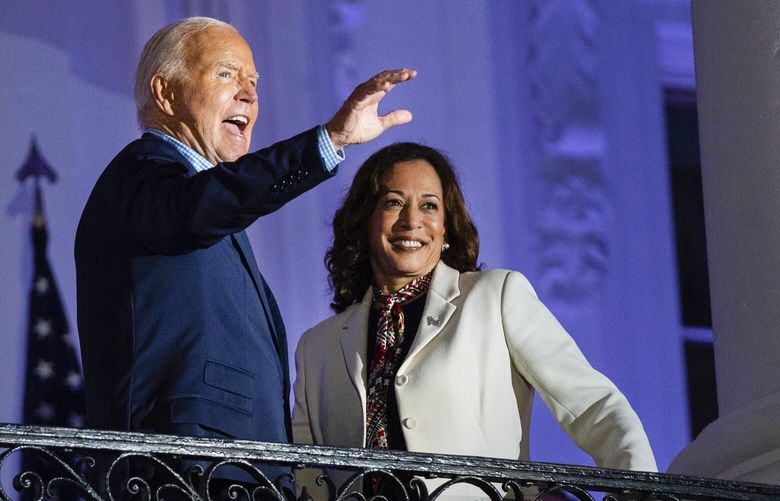 President Joe Biden and Vice President Kamala Harris wave to the crowd after viewing the Independence Day firework display over the National Mall from the balcony of the White House, Thursday, July 4, 2024, in Washington. DCEV164