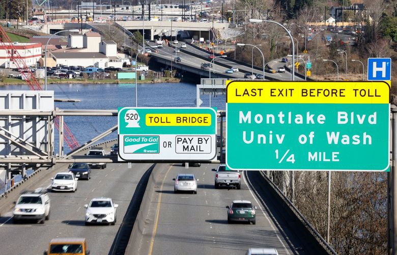 Looking east on SR 520 at toll bridge signs in Seattle on Tuesday, March 5, 2024.