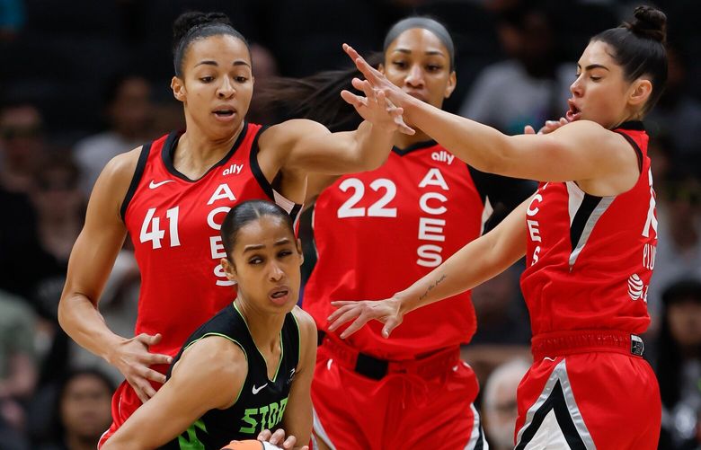 Seattle Storm guard Skylar Diggins-Smith gets turned away from the lane by Las Vegas Aces center Kiah Stokes, left, center A’ja Wilson and guard Kelsey Plum during the first quarter Wednesday, July 10, 2024 in Seattle. 227420