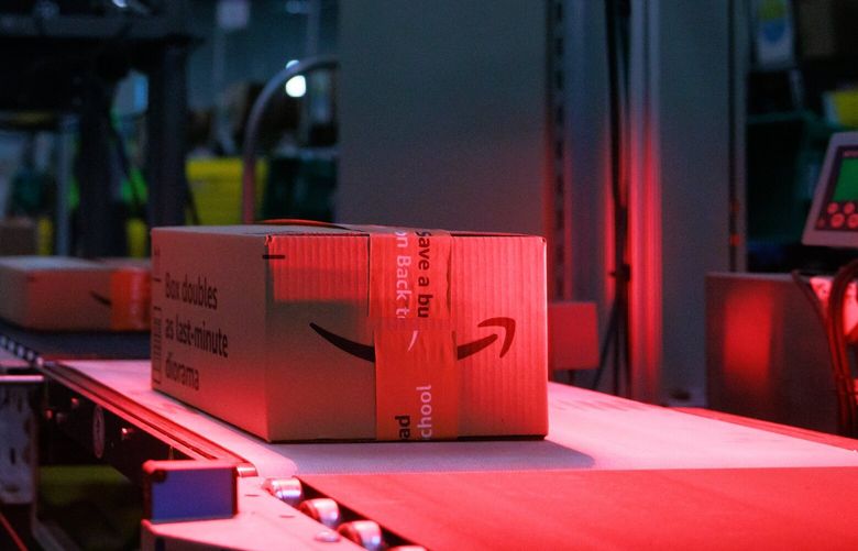 Single packages are transported by conveyor belt and weighed on the second-floor production floor of Amazon’s Kent fulfillment center in Kent, Wash. Friday, July 22, 2022. 221047