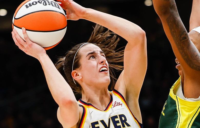 Caitlin Clark scores over Jordan Horston – and earns the foul – to make the game 81-79 Storm with 1:21 to play.   The Indiana Fever played the Seattle Storm in WNBA basketball Wednesday, May 22, 2024 at Climate Pledge Arena, in Seattle, WA. 226939