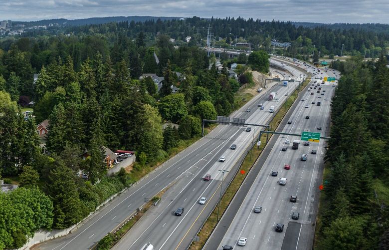 An aerial view looking north from Coal Creek Parkway, with downtown Bellevue in the background, shows Interstate 405, where a $705 million expansion project will result in two toll lanes and two free lanes each way, along with pockets of additional exit lanes, between Renton and Bellevue.