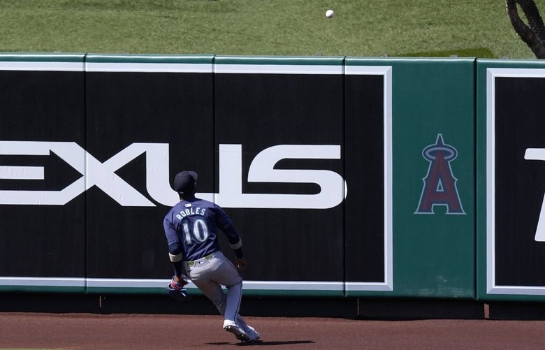 Seattle Mariners’ Victor Robles watches a ball hit by Los Angeles Angels’ Jo Adell go our for a three-run home run during the eighth inning of a baseball game Sunday, July 14, 2024, in Anaheim, Calif. (AP Photo/Mark J. Terrill) ANS120 ANS120