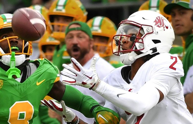 Washington State wide receiver Kyle Williams (2) hauls in a pass as Oregon defensive back Dontae Manning (8) defends during the first half of an NCAA college football game Saturday, Oct. 21, 2023, in Eugene, Ore. (AP Photo/Andy Nelson) ORAN107 ORAN107 ORAN107