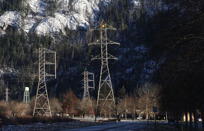 High-voltage transmission lines seen in Newhalem along SR 20 in the western foothills of the North Cascades on Friday, January, 12, 2024. Newhalem is a company town owned by Seattle City Light. The Skagit River Hydroelectric Project consists of a series of dams and hydroelectric power-generating stations including the Gorge Powerhouse just around the bend on the left.