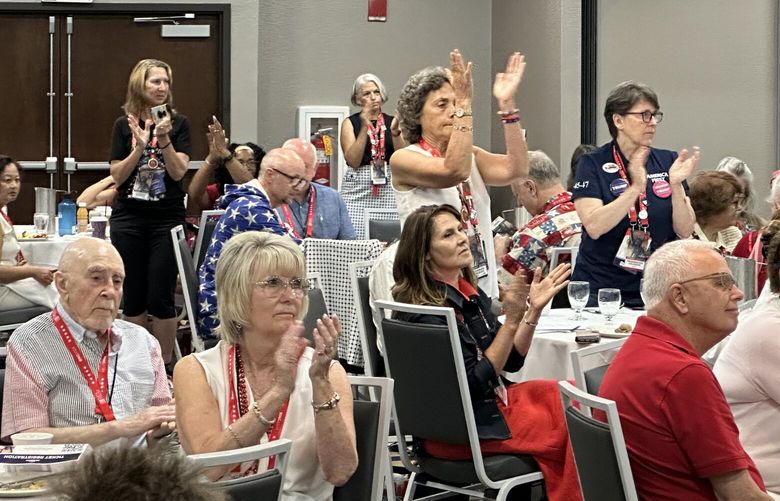 WA delegates cheer at their morning meeting at the hotel they’re staying at in Menomonee Falls, Wisconsin, during the National Republican Convention.