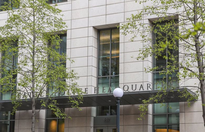 A cyclist bikes past the Seattle Police Department headquarters in downtown Seattle on Friday, April 26, 2024. 

 226756