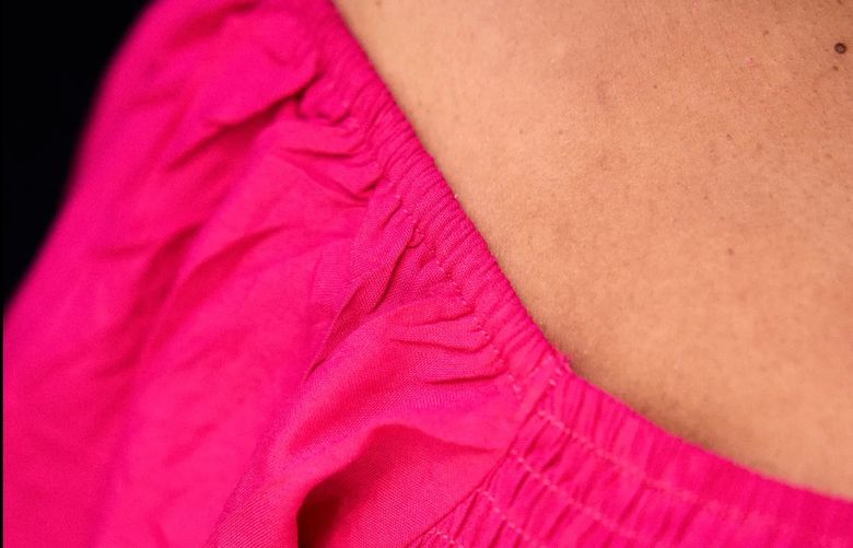 A detail of the pink fabric worn by stylist Denise Caldwell. Dressing for summer heat isn’t just about wearing less. Scientists and stylists say it’s about thoughtfully choosing fabrics, colors and fit. 
(Jesse Dittmar for The Washington Post)