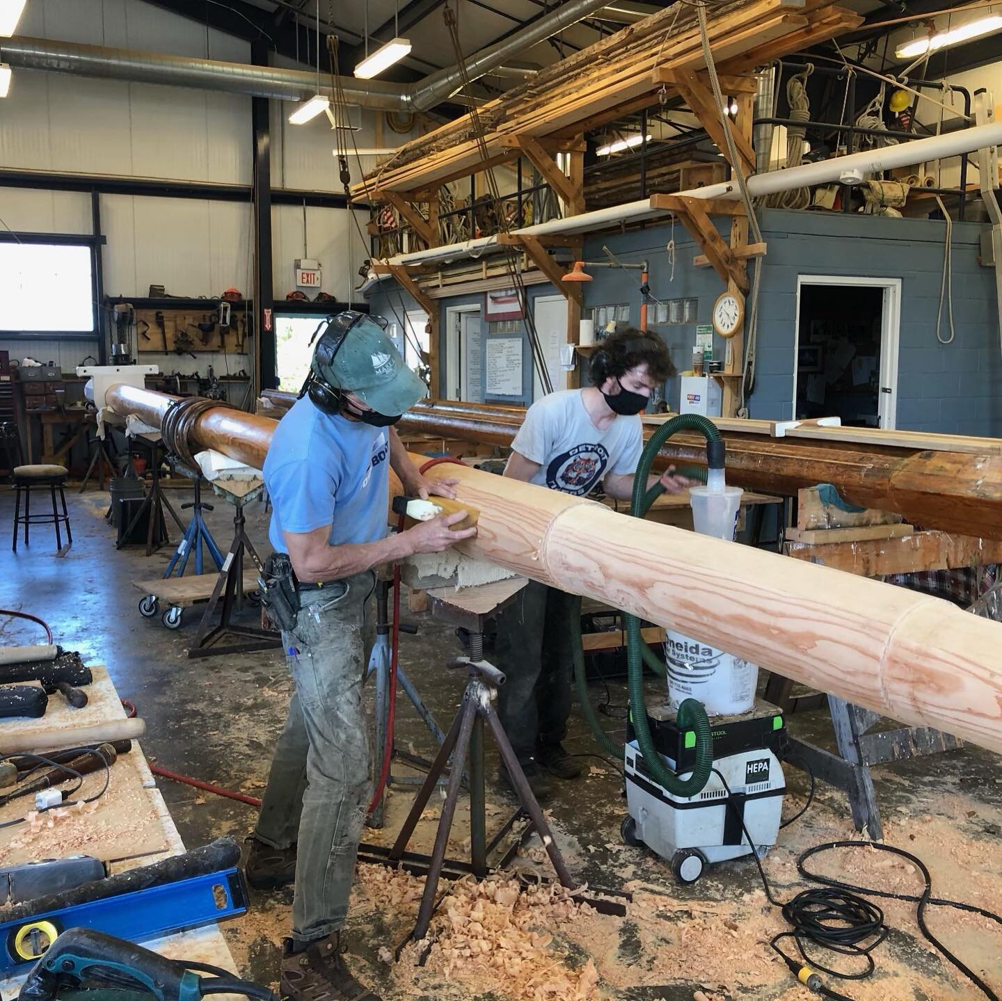 We&rsquo;re coming to an end of our #behindthescenes of building Christeens new mast! Here, after oiling the whole mast, they once again shave and sand it down to fit the shackles. They must cut indents for where the original shackles will be placed.