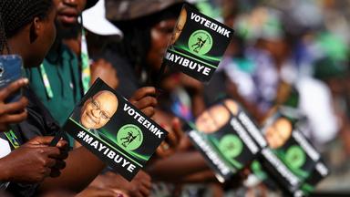 Anhänger der neuen politischen Partei des ehemaligen südafrikanischen Präsidenten Jacob Zuma halten Flugblätter