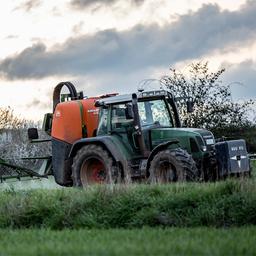 Ein Landwirt fährt mit einer Pestizid- und Düngerspritze über ein Feld