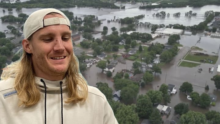 Pictured: Andrew Van Ginkel, with an aerial view of flooding in Rock Valley, Iowa in the background. 