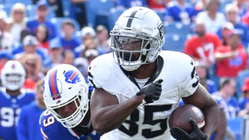 Sep 17, 2023; Orchard Park, New York, USA; Las Vegas Raiders running back Zamir White (35) runs past Buffalo Bills defensive tackle Tim Settle (99) in the fourth quarter at Highmark Stadium. Mandatory Credit: Mark Konezny-USA TODAY Sports