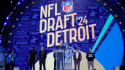 NFL commissioner Roger Goodell addresses the crowd with Eminem and the Detroit Lions' Jared Goff, Amon-Ra St. Brown and Aidan Hutchinson and Hall of Famers Calvin Johnson and Barry Sanders on the stage before Round 1 of the NFL draft on April 25, 2024 in Detroit.