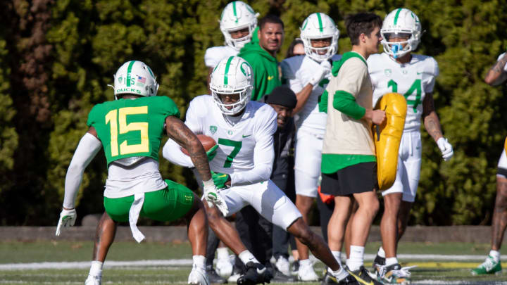 Oregon wide receiver Evan Stewart attempts to avoid defensive back Solomon Davis during practice with the Oregon Ducks Tuesday, April 9, 2024, at the Hatfield-Dowlin Complex in Eugene, Ore.