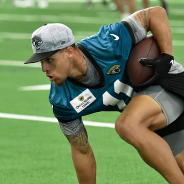 Jacksonville Jaguars wide receiver Parker Washington (11) turns to run down the sideline after pulling in a pass during drills. The Jacksonville Jaguars let most of the veterans off from participating in Monday's mandatory minicamp session held in the air conditioned enclosed field at EverBank Stadium's Miller Electric Center in Jacksonville, Fla. June 10, 2024. [Bob Self/Florida Times-Union]