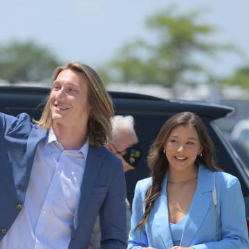 Trevor Lawrence waves at waiting students as he and his wife Marissa Mowry arrive at TIAA Bank Field Friday. The Jacksonville Jaguars' first-round draft pick Trevor Lawrence and his wife Marissa Mowry arrived at TIAA Bank Field in Jacksonville, Florida about noon Friday, April 30, 2021. The couple was greeted by team owner Shad Khan and 35 third-grade students from Long Branch Elementary School.