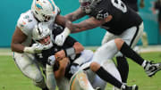 Miami Dolphins linebacker Jaelan Phillips (15) and defensive tackle Christian Wilkins (94) sack Las Vegas Raiders quarterback Aidan O'Connell (4) during the second half of an NFL game at Hard Rock Stadium in Miami Gardens, Nov. 19, 2023.