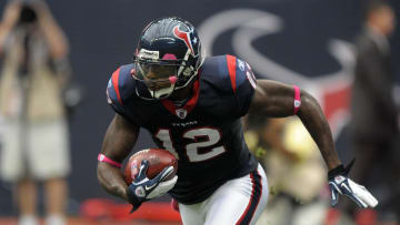 Oct 9, 2011; Houston, TX, USA; Houston Texans receiver Jacoby Jones (12) carries a ball with a NFL pink breast cancer awareness logo during the game against the Oakland Raiders at Reliant Stadium. The Raiders defeated the Texans 25-20. Mandatory Credit: Kirby Lee/Image of Sport-USA TODAY Sports