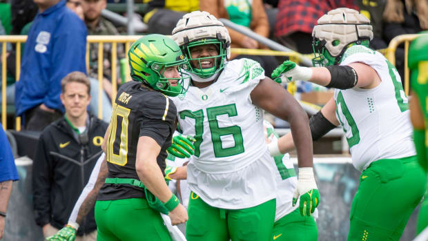 Oregon quarterback Luke Moga and offensive lineman Josh Connerly Jr. celebrate after a touchdown during the Spring Game.