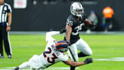 Jan 7, 2024; Paradise, Nevada, USA; Las Vegas Raiders running back Zamir White (35) breaks the tackle of Denver Broncos cornerback Fabian Moreau (23) during the second quarter at Allegiant Stadium. Mandatory Credit: Stephen R. Sylvanie-USA TODAY Sports