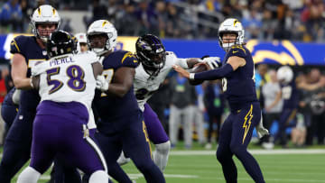 Nov 26, 2023; Inglewood, California, USA; Baltimore Ravens linebacker Jadeveon Clowney (24) forces a fumble by Los Angeles Chargers quarterback Justin Herbert (10) during the fourth quarter at SoFi Stadium. Mandatory Credit: Kiyoshi Mio-USA TODAY Sports