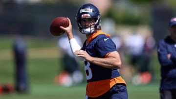 Denver Broncos quarterback Jarrett Stidham drops back during organized team activities.