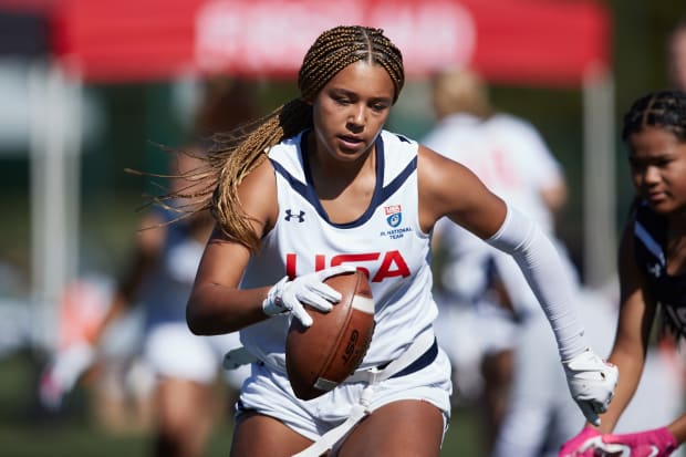 A female football player trains in Under Armour gear.