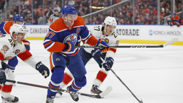 Nov 28, 2022; Edmonton, Alberta, CAN; Edmonton Oilers forward Connor McDavid (97) breaks in between Florida Panthers defensemen Gustav Forsling (42) and forward Eetu Luostarinen (27) during the first period at Rogers Place. Mandatory Credit: Perry Nelson-USA TODAY Sports