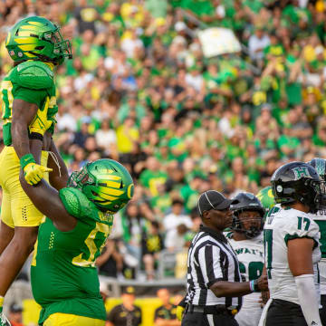 Oregon running back Jordan James is lifted into the air by teammate Marcus Harper II to celebrate a touchdown as the Oregon Ducks host Hawaii Saturday, Sept. 16, 2023, at Hayward Field in Eugene, Ore.