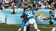 Dec 31, 2023; Jacksonville, Florida, USA; Jacksonville Jaguars corner back Tyson Campbell (32) tackles Carolina Panthers wide receiver Jonathan Mingo (15) during the first quarter at EverBank Stadium. Mandatory Credit: Morgan Tencza-USA TODAY Sports