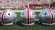 Sep 2, 2023; Bloomington, Indiana, USA; Ohio State Buckeyes helmets sit on the sideline prior to the NCAA football game at Indiana University Memorial Stadium.