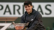 Jun 9, 2024; Paris, France; Carlos Alcaraz of Spain poses with the trophy after winning the men’s singles final against Alexander Zverev of Germany on day 15 of Roland Garros at Stade Roland Garros.