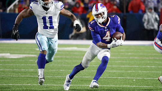 Buffalo Bills running back James Cook (4) gets extra yards as he runs past Dallas Cowboys linebacker Micah Parsons (11). Cook rushed for 179 yards in a 31-10 win.