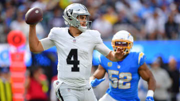 Oct 1, 2023; Inglewood, California, USA; Las Vegas Raiders quarterback Aidan O'Connell (4) throws as Los Angeles Chargers linebacker Khalil Mack (52) moves in during the second half at SoFi Stadium. Mandatory Credit: Gary A. Vasquez-USA TODAY Sports