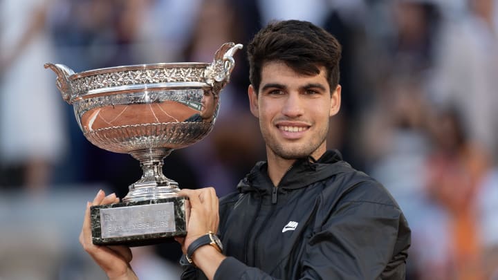 Jun 9, 2024; Paris, France; Carlos Alcaraz of Spain poses with the trophy after winning the men’s singles final against Alexander Zverev of Germany on day 15 of Roland Garros at Stade Roland Garros. 