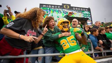 Oregon running back Brison Cobbins leaps into the stands as the No. 9 Oregon Ducks host Washington State Saturday, Oct. 21, 2023, at Autzen Stadium in Eugene, Ore.