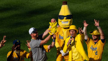 The Savannah Bananas hold up a baby Thursday, June 27, 2024, during a Savannah Bananas World Tour show at Victory Field in Indianapolis.