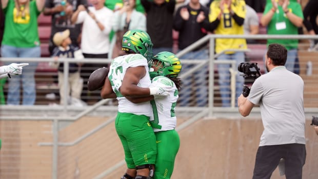 Oregon Ducks running back Jordan James celebrates with offensive lineman Ajani Cornelius.