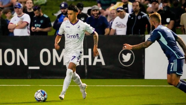 May 8, 2024; Omaha, Nebraska, USA; Union Omaha midfielder Joe Gallardo (7) drives against Sporting Kansas City forward Johnny Russell (7) during the second half at Al F. Caniglia Field. Mandatory Credit: Dylan Widger-USA TODAY Sports