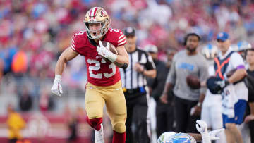 Jan 28, 2024; Santa Clara, California, USA; San Francisco 49ers running back Christian McCaffrey (23) runs with the ball against Detroit Lions safety C.J. Gardner-Johnson (2) during the first half of the NFC Championship football game at Levi's Stadium. Mandatory Credit: Kyle Terada-USA TODAY Sports