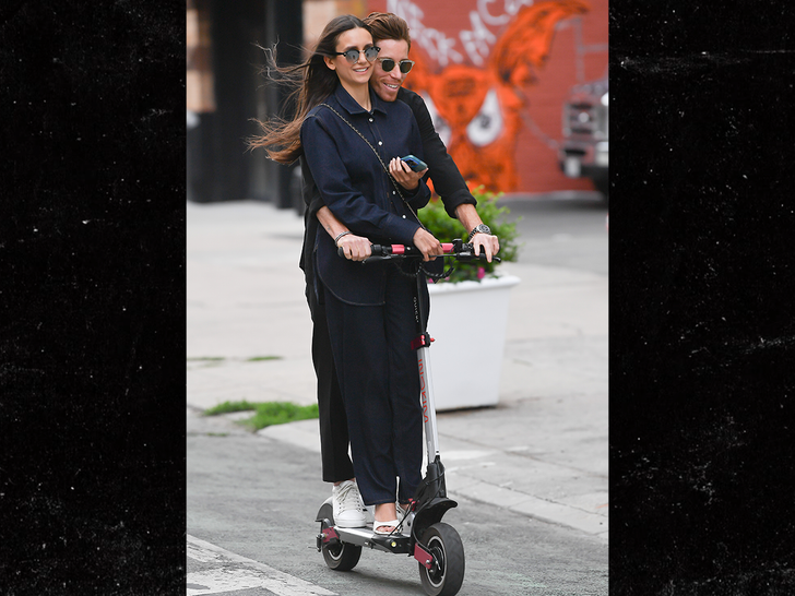 Nina Dobrev and Shaun White ride a scooter