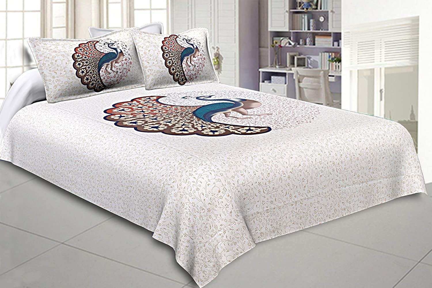 A peacock bedsheet on a bed