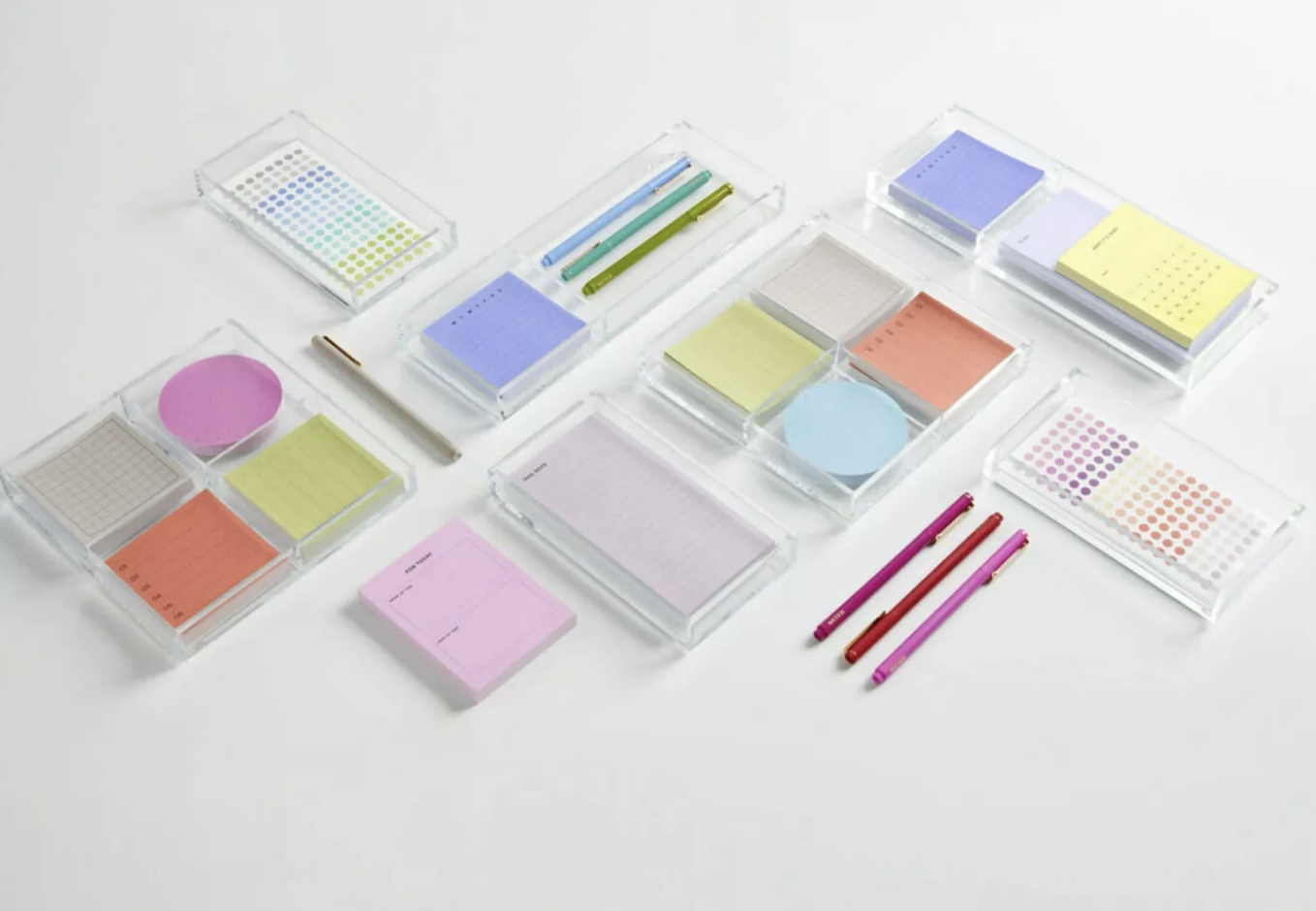 A variety of acrylic Post-it trays and organizers