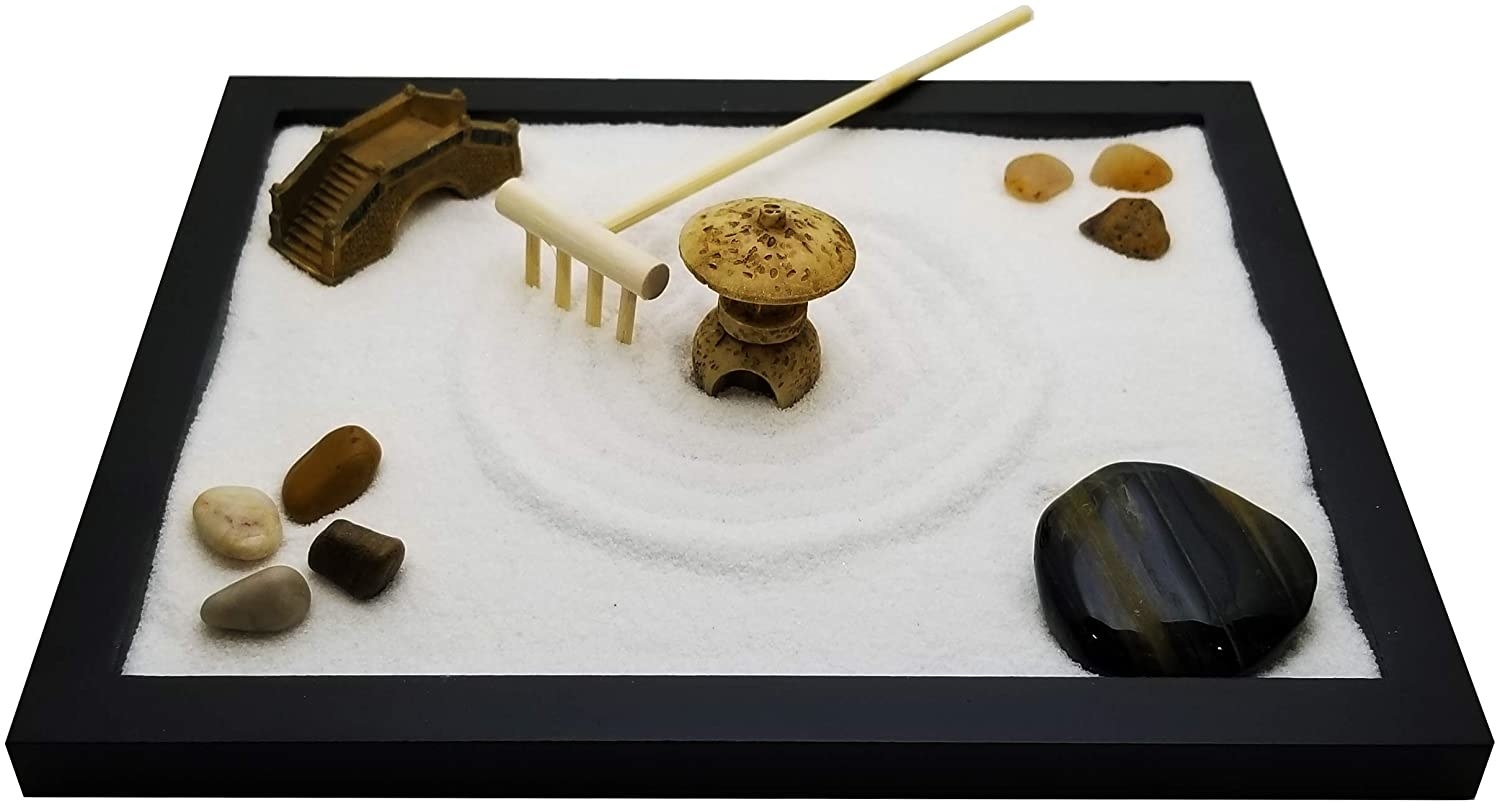 The meditation garden which comes with sand, rocks, figurines, and a rake