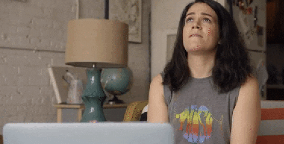 Woman looking away from her computer anxiously 