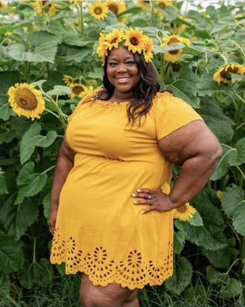 Reviewer in yellow version of the dress, which falls mid-thigh and cinches at waist 