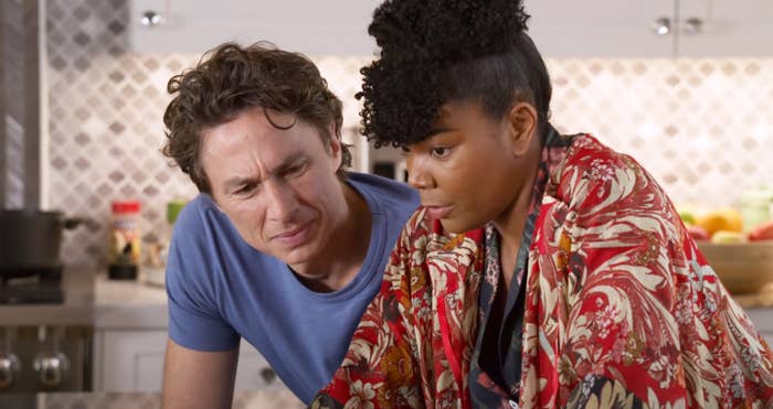 Gabrielle and Zack leaning over the kitchen table in a scene from the movie