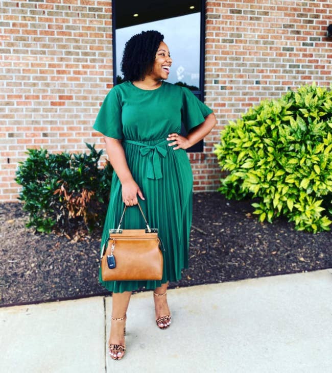 A customer review photo of them in the dress in green