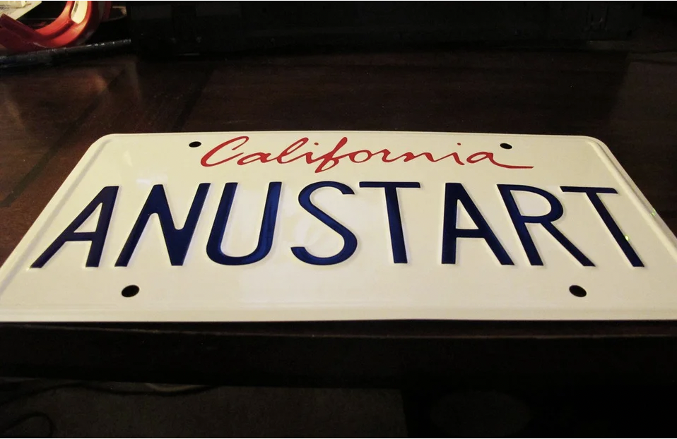 Car with license plate reading &quot;ANUSTART&quot;